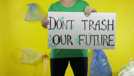 Unrecognizable-woman-holding-protesting-poster-Don't-Trash-Our-Future.-Environment-plastic-pollution