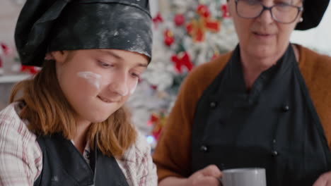 Portrait-of-granddaughter-with-flour-ingredient-on-face-preparing-gingerbread-dessert