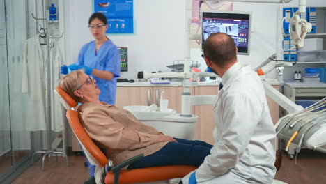 Assistant-preparing-patient-for-dental-intervention