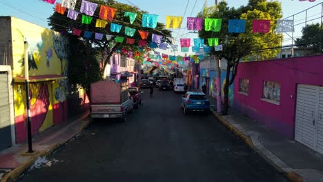 Dolly-in-a-closed-and-colorfully-decorated-street-in-Iztapalapa,-Mexico-City