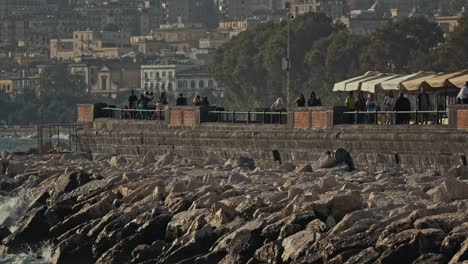 Rocky-shore-and-promenade,-Naples,-Italy