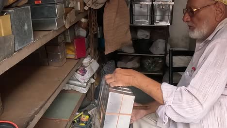 A-shopkeeper-cleans-and-arranges-items-in-his-shop