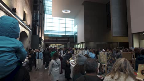 POV-Walking-Past-Busy-Festive-Stalls-At-Indoor-Market-In-Kings-Cross-During-December