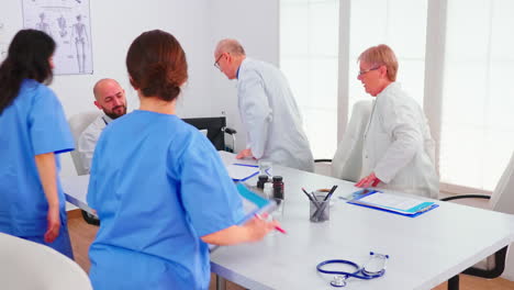 Doctor-specialist-briefing-his-medical-team-in-hospital-conference-room