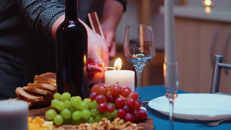 Close-up-of-woman-lighting-the-candle