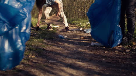 Diverse-group-of-volunteers-picking-up-trash-and-plastic-to-recycle