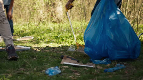 Team-of-volunteers-collecting-rubbish-to-fix-pollution-problem-within-the-forest-habitat