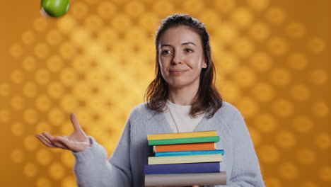 Cheerful-person-holding-books,-playing-with-fresh-fruit,-good-lifestyle-concept