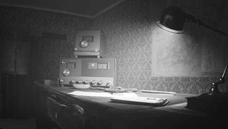 Retro-communication-room-filled-with-dust,-with-old-furniture,-old-fashioned-background-on-the-wall-and-wooden-desk.-Vintage-radio-station-standing-on-the-desk-under-obsolete-lamp