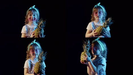 Stylish-teen-caucasian-kid-girl-with-pineapple-standing-on-black-background-singing,-fooling-around