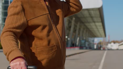 Portrait-of-senior-pensioner-tourist-grandfather-stay-near-airport-hall-waiting-for-plane,-travel