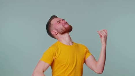 Overjoyed-happy-man-showing-rock-n-roll-gesture-by-hands,-cool-sign,-shouting-yeah-with-crazy-face