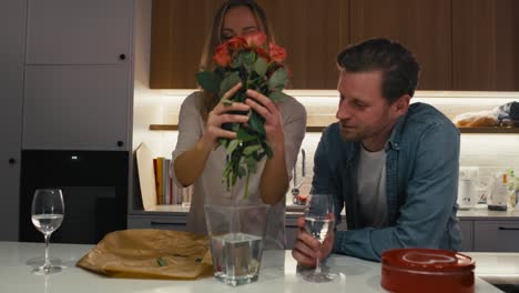 Woman-putting-a-bunch-of-flowers-into-the-vase