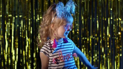 Portrait-of-trendy-stylish-girl-showing-magic-tricks-gestures,-fooling-around-at-disco-night-club