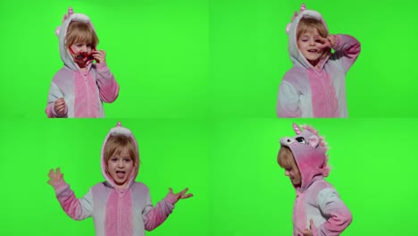 Child-girl-in-unicorn-pajamas-making-silly-funny-faces,-fooling-around,-showing-tongue-on-chroma-key