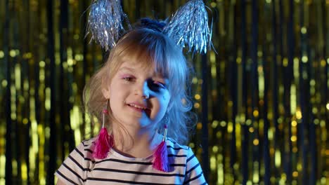 Portrait-of-trendy-stylish-girl-looking-at-camera,-smiling,-child-kid-in-neon-light-at-disco-club