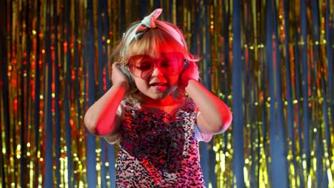 Futuristic-teen-girl-listening-to-music-in-headphones,-dancing-in-slow-motion-at-disco-party-club