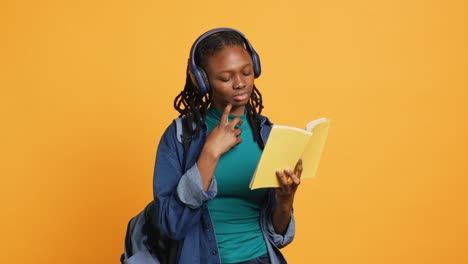 Una-Joven-Con-Auriculares-Leyendo-Un-Libro-Interesante,-Fondo-De-Estudio