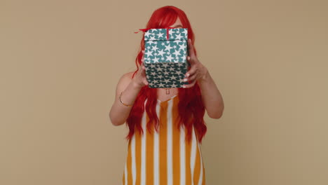 Redhead-ginger-girl-presenting-birthday-gift-box-offer-wrapped-present-career-bonus-celebrating
