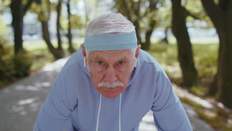 Abuelo-Hombre-Atlético-Senior-Corriendo-Jogging-En-El-Parque-Soleado-Durante-El-Entrenamiento-Cardiovascular-De-La-Mañana-Al-Aire-Libre