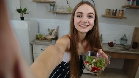 POV-shot-of-blogger-girl-making-photos,-taking-selfies-with-salad-for-social-media-on-mobile-phone