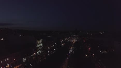 Arial-view-of-Lviv-Christmas-tree-near-Opera-house,-Festive-lights,-and-Fair-market-on-winter-night