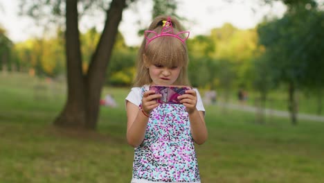 Children-girl-loses-on-mobile-phone-game,-use-squishy-silicone-anti-stress-pop-it-toy-to-calm-down