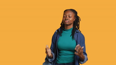 Spiritual-girl-doing-worship-hand-gesturing,-spreading-arms,-studio-background