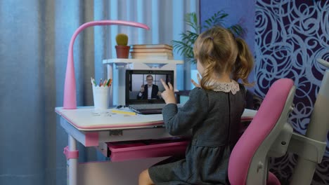 Girl-doing-online-homework-with-teacher,-using-digital-laptop-computer-at-home,-distance-education