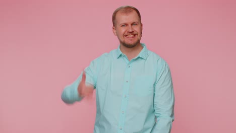 Cheerful-one-man-in-shirt-looking-at-camera-doing-phone-gesture-like-says-hey-you-call-me-back