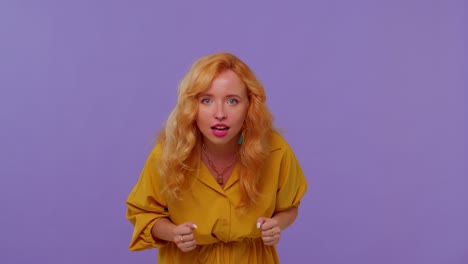 Redhead-girl-in-yellow-dress-shouting-raising-fists-in-gesture-I-did-it-celebrating-success,-winning