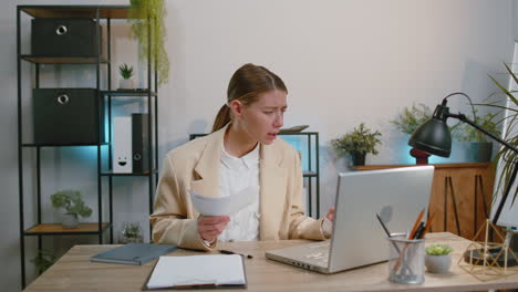 Stressed-businesswoman-looking-at-unpaid-bank-debt-loan-throws-paper-document-bills-financial-crisis