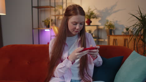 Worried-funny-young-teen-child-girl-kid-playing-racing-online-video-games-on-smartphone-at-home