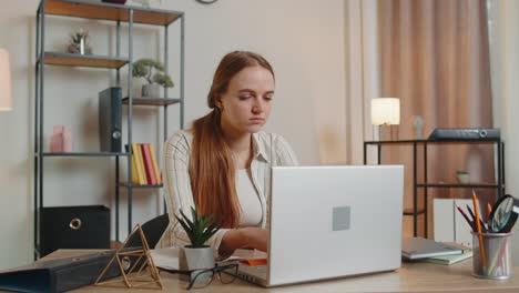 Tired-woman-teacher-using-laptop-computer-with-funny-stickers-on-eyes-sleeps-at-workplace,-napping