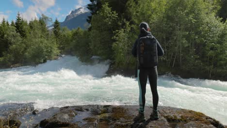 Hiking-woman-walk-with-a-hiking-backpack-in-Beautiful-nature-of-Norway.