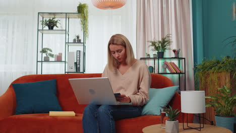 Girl-student-study-at-home-couch-on-laptop-computer-making-conference-video-call-talking-to-webcam