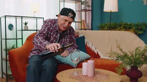 Smiling-senior-grandfather-man-drinking-red-wine-glass-celebrating-birthday-anniversary-lottery-win