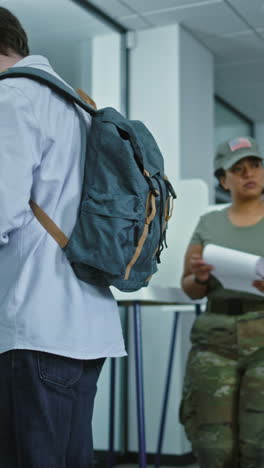 Dolly-shot-of-diverse-American-citizens-voting-in-booths-in-polling-station-office.-National-Election-Day-in-the-United-States.-Political-races-of-US-presidential-candidates.-Concept-of-civic-duty.