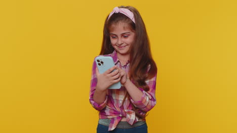 Child-girl-kid-use-mobile-smartphone-browsing-say-Wow-yes-found-out-great-win-good-news-celebrate