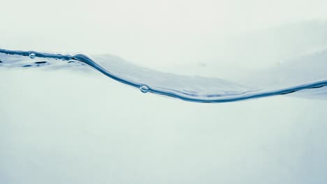 Many-bubbles-in-water-close-up,-abstract-water-wave-with-bubbles-in-slow-motion