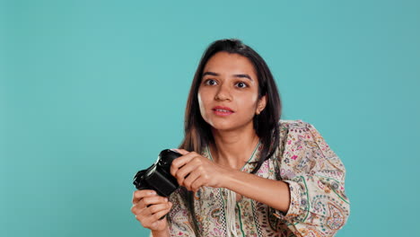 Focused-woman-playing-videogames-with-motion-controlled-joystick