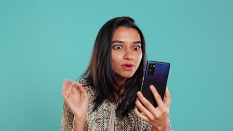 Irked-woman-fighting-with-friends-during-smartphone-videocall