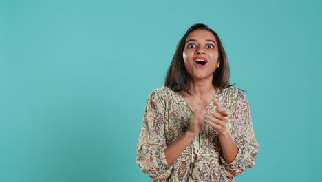 Woman-happily-clapping-hands,-reacting-to-good-news