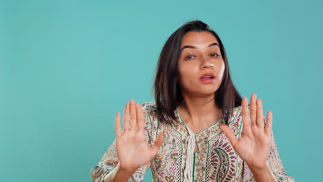 Stern-woman-doing-stop-hand-gesture-sign,-complaining