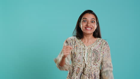 Portrait-of-joyful-woman-celebrating,-showing-positive-emotions,