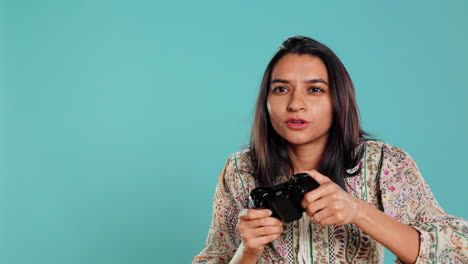 Joyful-woman-showing-thumbs-up-sign-gesturing-while-holding-controller