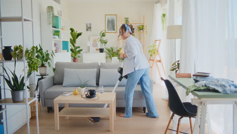 Happy-Woman-Dancing-While-Vacuuming