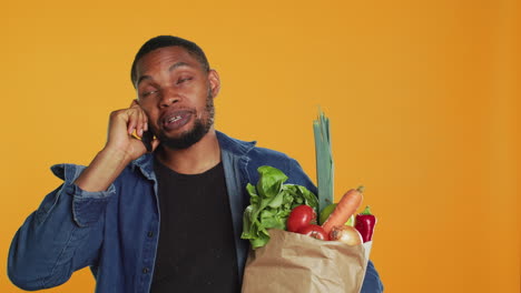 African-american-man-on-grocery-shopping-spree-chatting-on-phone-call