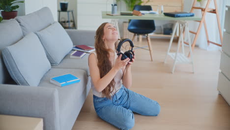 Woman-Closes-Book-Puts-on-Headphones-to-Relax