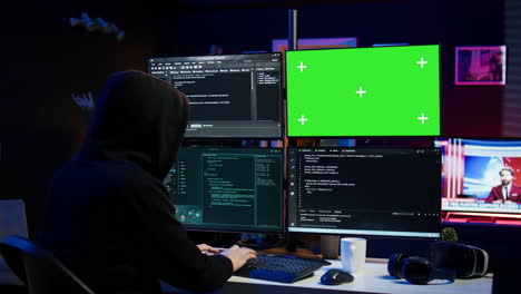 Close-up-of-hacker-running-code-in-apartment-on-PC-monitors